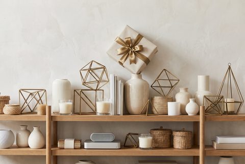 Pristine white shelves of minimalist decor with a single wrapped gift on top