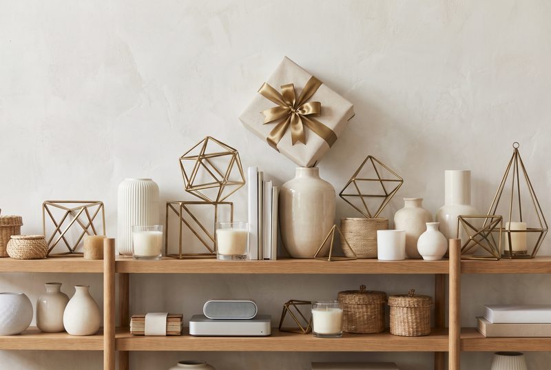 Pristine white shelves of minimalist decor with a single wrapped gift on top